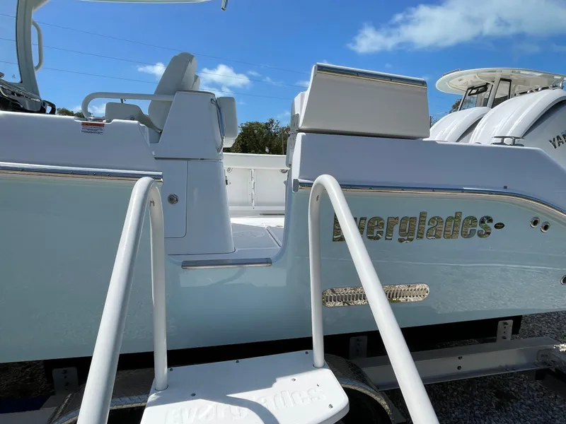 Slide: The Image of 2024 Everglades 285CC boat with white seating and sleek design under a clear blue sky. - 32