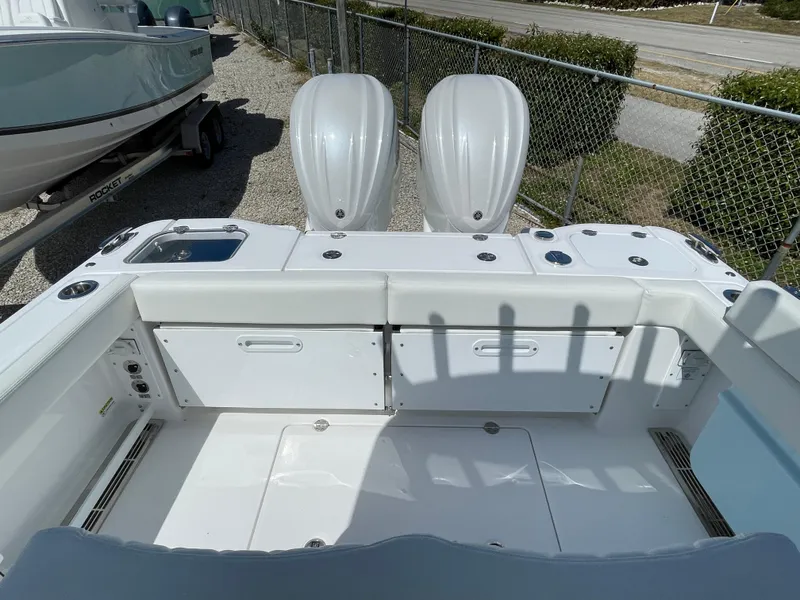 Slide: The Image of 2024 Everglades 285CC boat with dual engines, white interior, and storage compartments. - 6