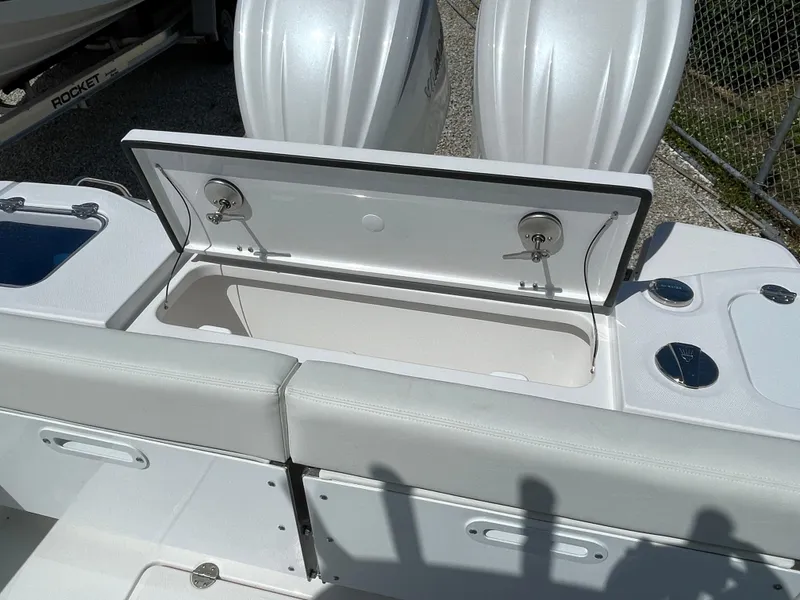 Slide: The Image of 2024 Everglades 285CC boat with open storage compartment and dual engines. - 9