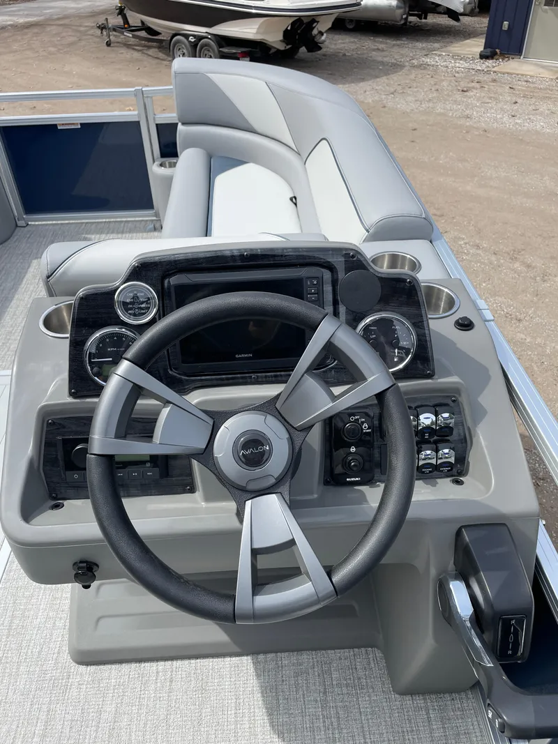 Slide: The Image of Steering console of 2025 Avalon 23 Venture 85 VRB boat with modern controls and seating. - 3