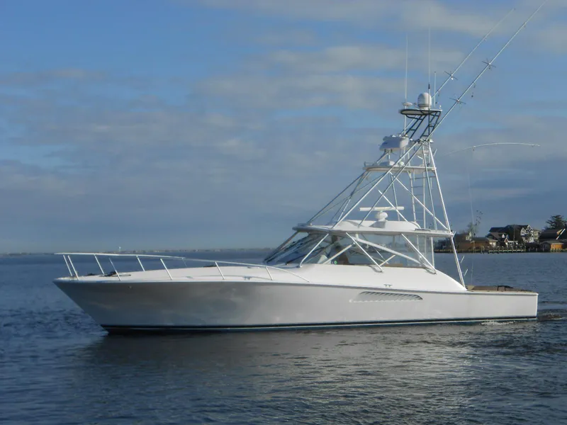 Slide: The Image of 2007 Viking Boats 52 Open yacht on calm water under a cloudy sky. - 1