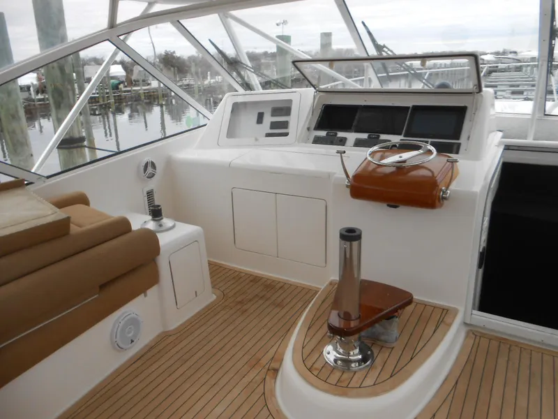 Slide: The Image of 2007 Viking Boats 52 Open helm with wooden accents and modern navigation equipment. - 14