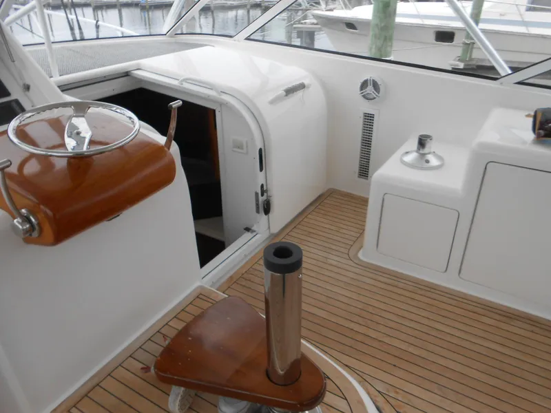 Slide: The Image of 2007 Viking Boats 52 Open interior with teak flooring and sleek white cabinetry. - 15
