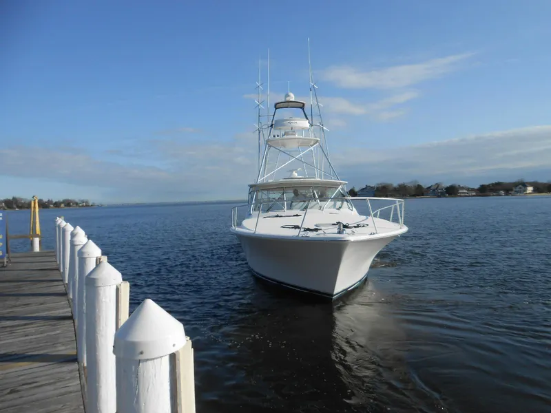 Slide: The Image of 2007 Viking Boats 52 Open yacht docked on calm water under clear blue sky. - 2