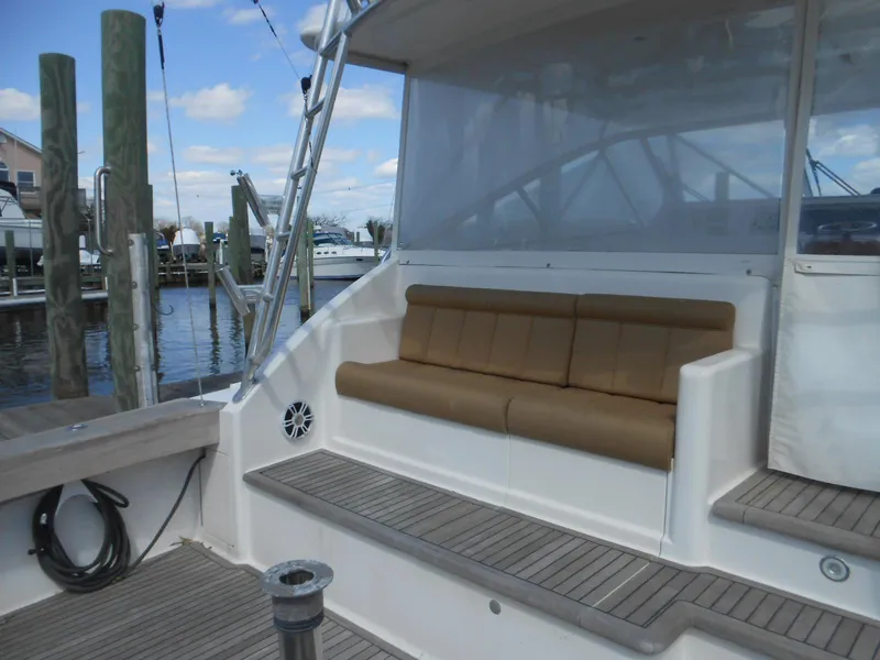 Slide: The Image of 2007 Viking Boats 52 Open yacht with cushioned seating on deck, docked at marina. - 21
