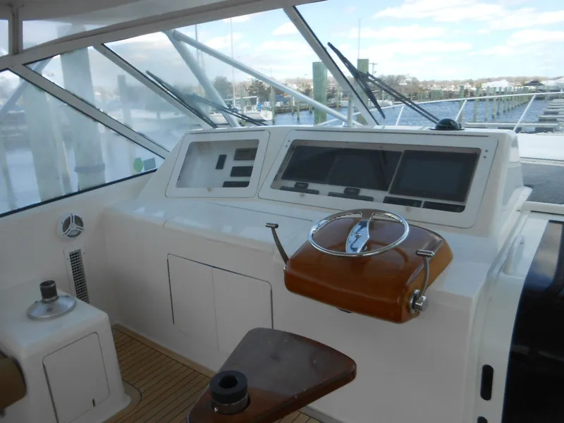 Slide: The Image of 2007 Viking Boats 52 Open helm with modern navigation equipment and wooden steering wheel. - 22