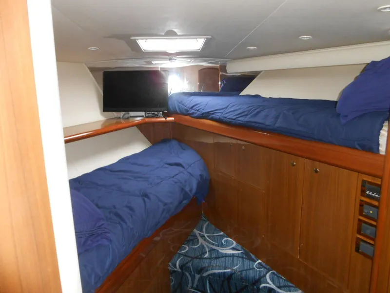 Slide: The Image of Interior cabin of 2007 Viking Boats 52 Open with twin beds and TV. - 24