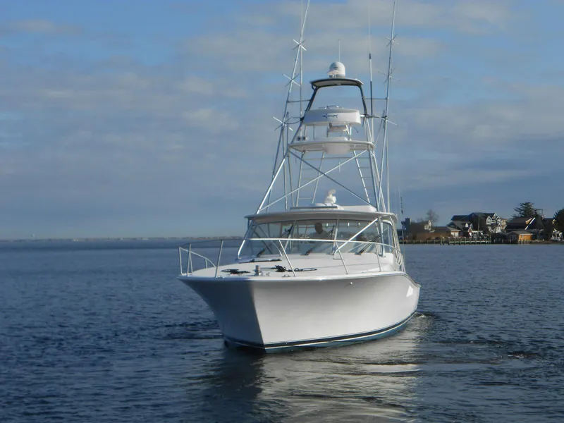 Slide: The Image of 2007 Viking Boats 52 Open yacht on calm water, showcasing sleek design and tower. - 3