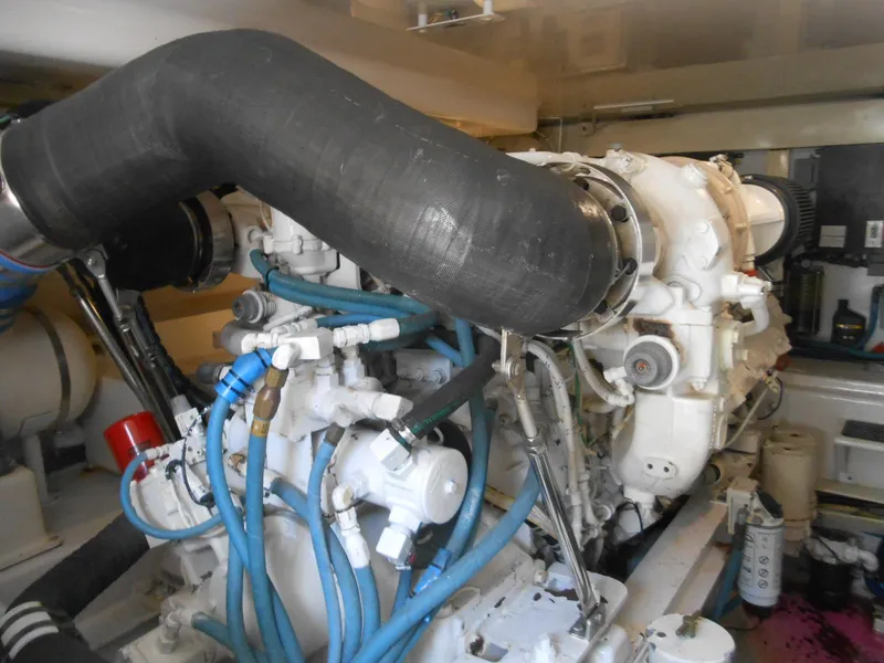 Slide: The Image of Engine room of 2007 Viking Boats 52 Open, featuring complex machinery and hoses. - 33