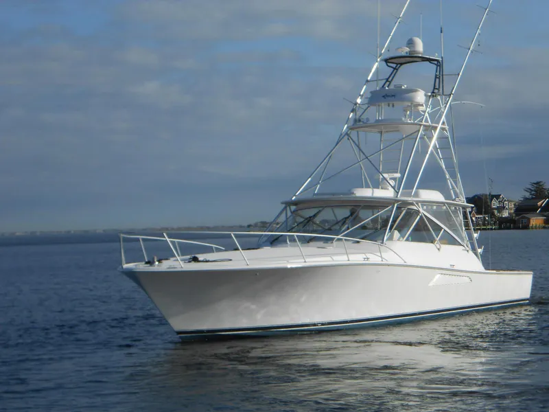 Slide: The Image of 2007 Viking Boats 52 Open yacht on calm water under a cloudy sky. - 4