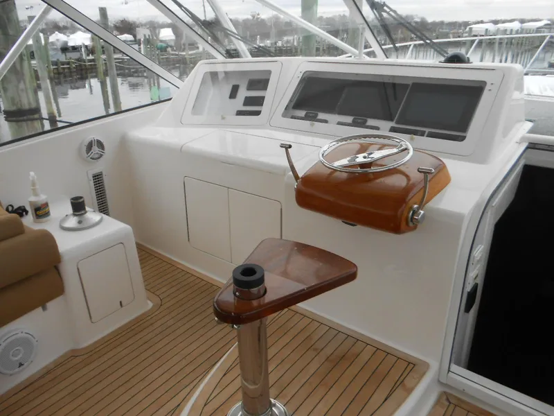 Slide: The Image of 2007 Viking Boats 52 Open helm with wooden steering wheel and modern controls. - 6