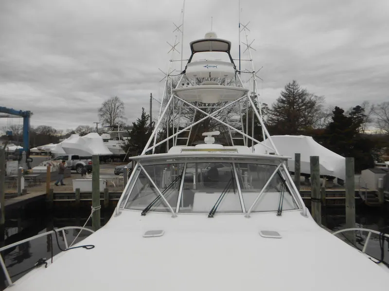 Slide: The Image of 2007 Viking Boats 52 Open docked, showcasing sleek design and tower structure. - 8