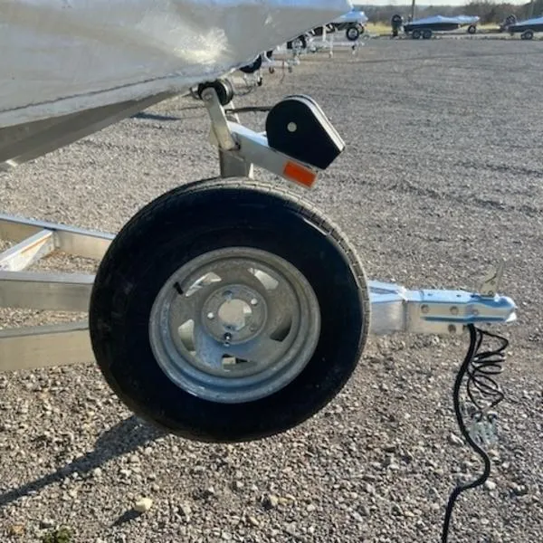 Slide: The Image of Trailer hitch and wheel of 2023 Xpress XP185 Catfish boat on gravel surface. - 5
