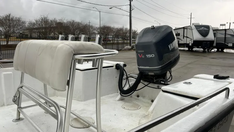 Slide: The Image of 2000 Blazer 1860 boat with Yamaha V6 150 outboard motor in a parking lot. - 10