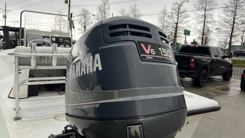 Slide: The Image of Boat with Yamaha V6 150 outboard motor, Blazer 1860 model, year 2000, in a parking lot. - 8