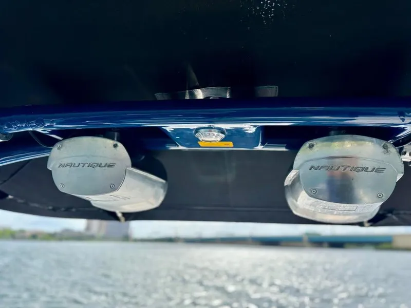 Slide: The Image of 2011 Nautique 200V boat underside with dual exhausts on water. - 10