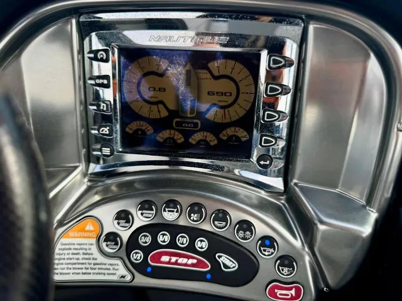 Slide: The Image of Dashboard of a 2011 Nautique 200V boat with digital gauges and control buttons. - 13