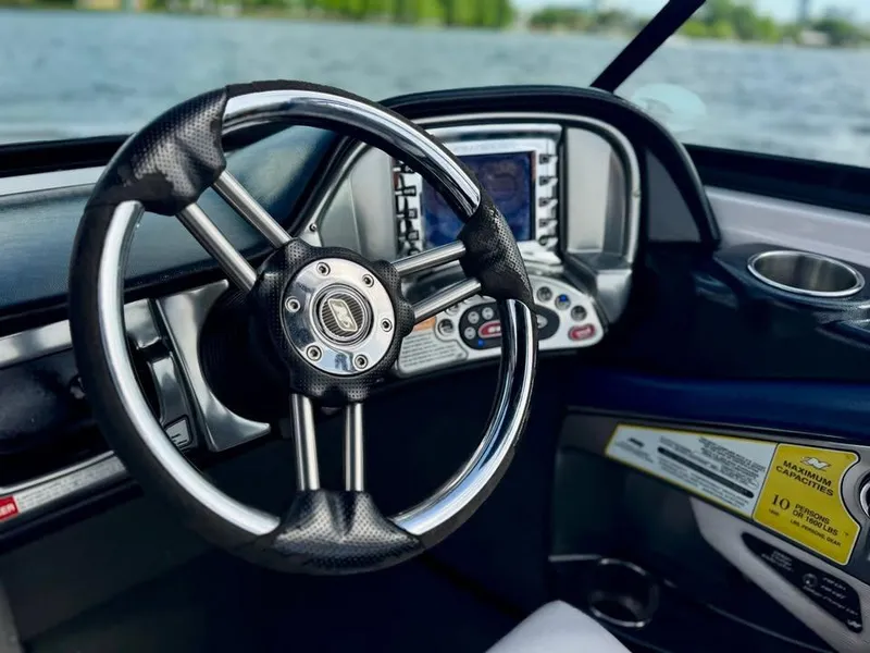 Slide: The Image of Steering wheel and dashboard of 2011 Nautique 200V boat with water view. - 14