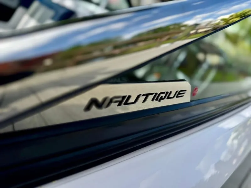 Slide: The Image of Close-up of 2011 Nautique 200V boat logo on reflective surface. - 17
