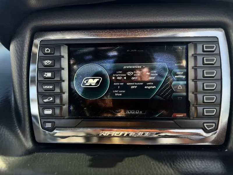 Slide: The Image of 2011 Nautique 200V dashboard display with control buttons and settings menu. - 18