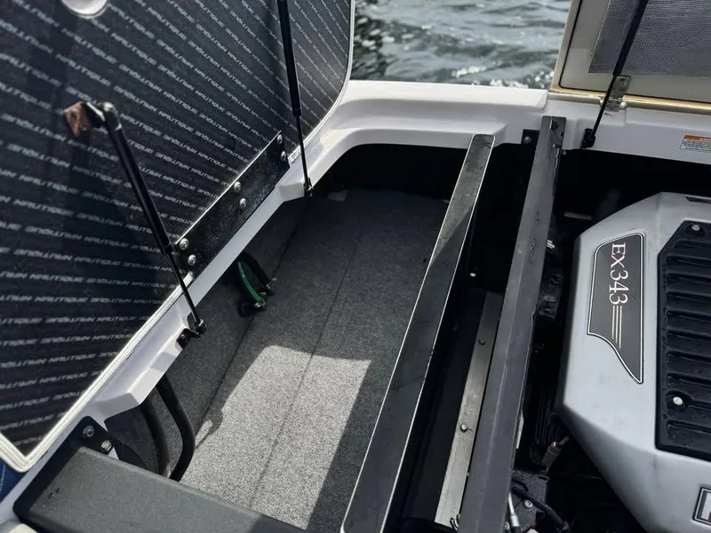 Slide: The Image of 2011 Nautique 200V boat engine compartment with EX343 engine, open storage area. - 3