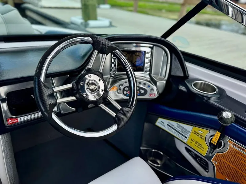 Slide: The Image of 2011 Nautique 200V boat dashboard with steering wheel and control panel. - 5