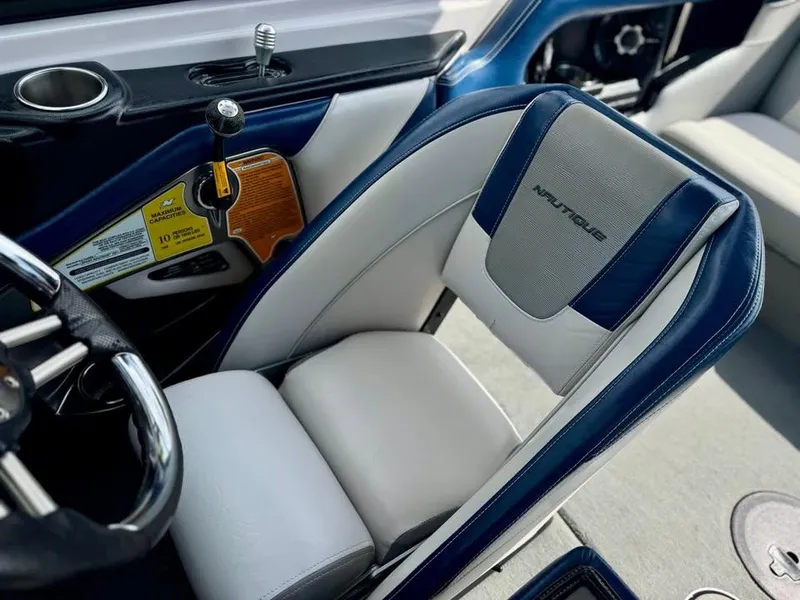 Slide: The Image of 2011 Nautique 200V boat interior with steering wheel and cushioned seat. - 7