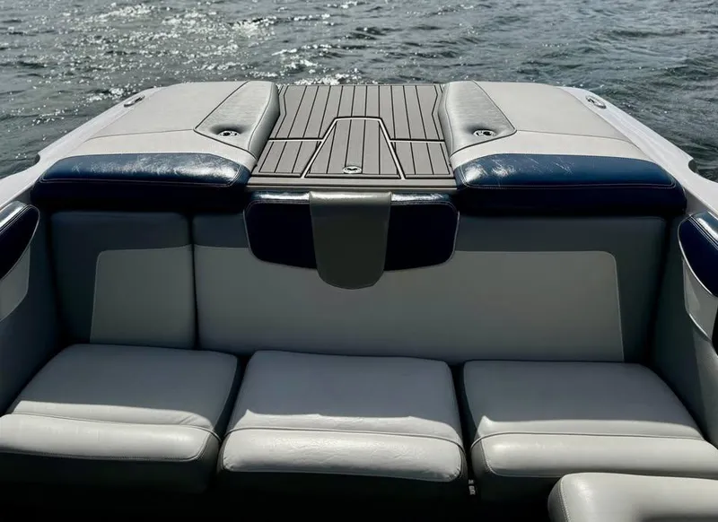 Slide: The Image of 2011 Nautique 200V boat interior with cushioned seating and water view. - 9