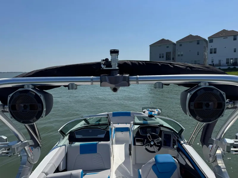 Slide: The Image of 2019 MasterCraft X24 boat interior with speakers, steering wheel, and lake view. - 28