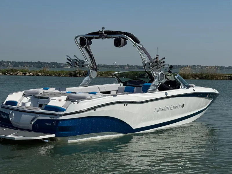 Slide: The Image of 2019 MasterCraft X24 boat on water, featuring sleek design and modern wakeboard tower. - 3