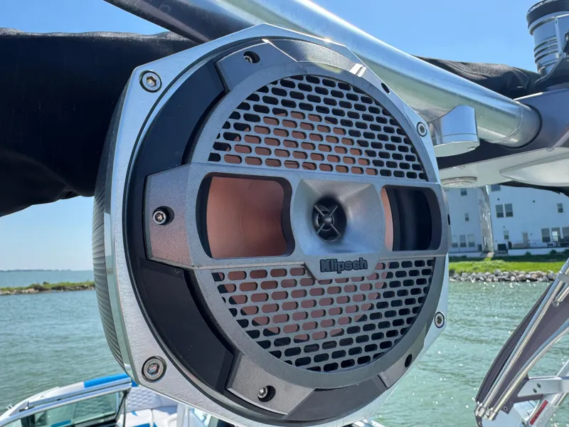 Slide: The Image of Klipsch speaker on 2019 MasterCraft X24 boat, mounted on a metal frame by the water. - 32