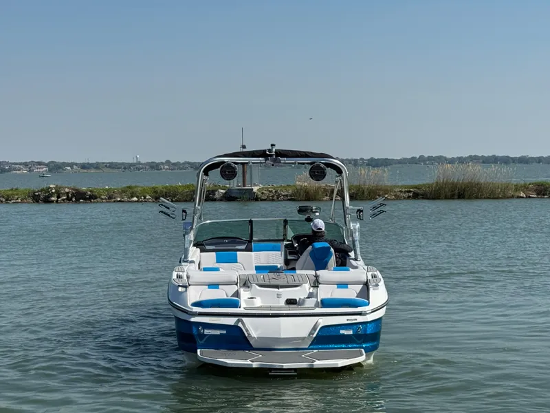 Slide: The Image of 2019 MasterCraft X24 boat on calm water, featuring blue and white design. - 5