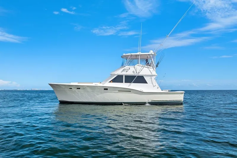 The Image of 1978 Hatteras 45 Convertible yacht on calm blue ocean under clear sky. - 1