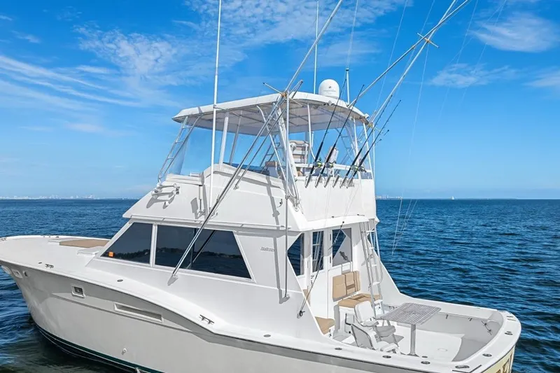 Slide: The Image of 1978 Hatteras 45 Convertible yacht on open water, clear sky background. - 16