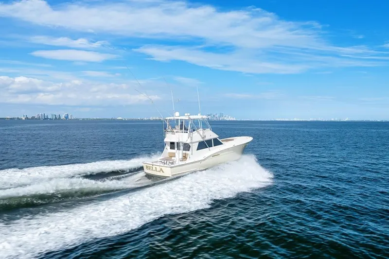 Slide: The Image of 1978 Hatteras 45 Convertible yacht cruising on open water under a clear blue sky. - 18