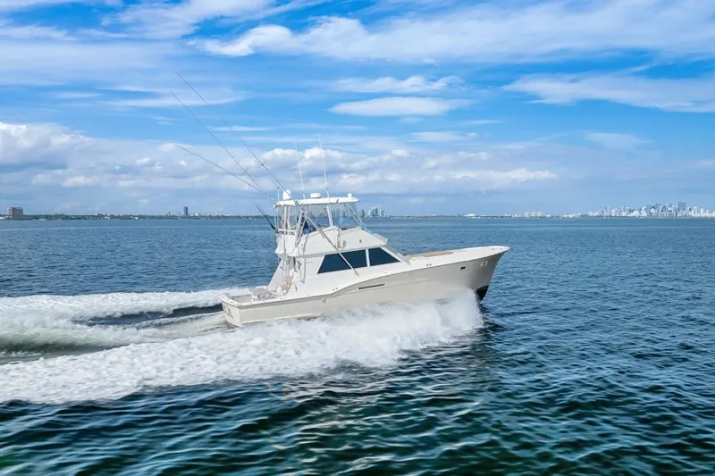 Slide: The Image of 1978 Hatteras 45 Convertible yacht cruising on open water under a clear blue sky. - 19