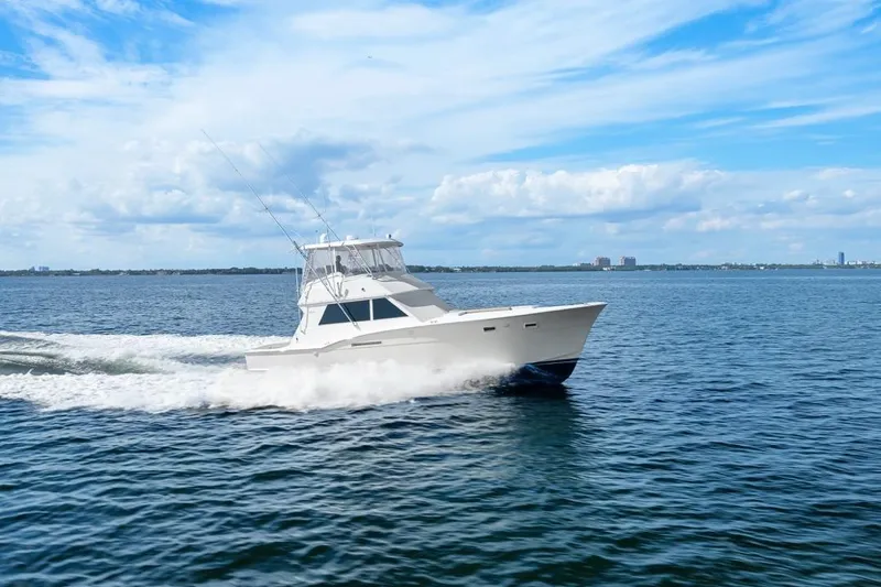 Slide: The Image of 1978 Hatteras 45 Convertible yacht cruising on open water under a clear blue sky. - 20