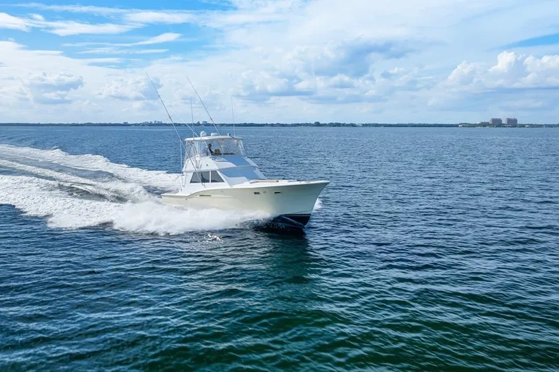 Slide: The Image of 1978 Hatteras 45 Convertible yacht cruising on open water under a blue sky. - 21