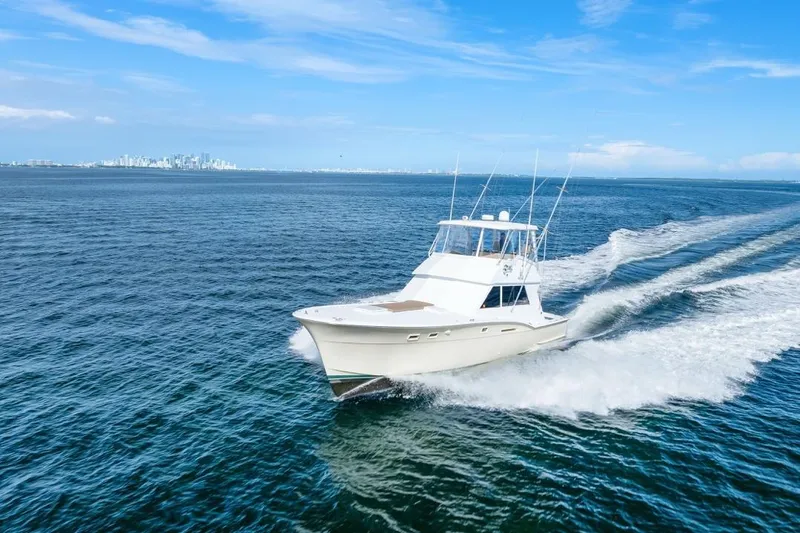Slide: The Image of 1978 Hatteras 45 Convertible yacht cruising on open blue water. - 24
