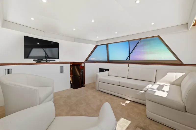Slide: The Image of Luxurious interior of 1978 Hatteras 45 Convertible yacht with modern seating and TV. - 25
