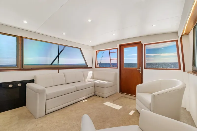 Slide: The Image of Interior of 1978 Hatteras 45 Convertible yacht with modern seating and ocean view. - 26