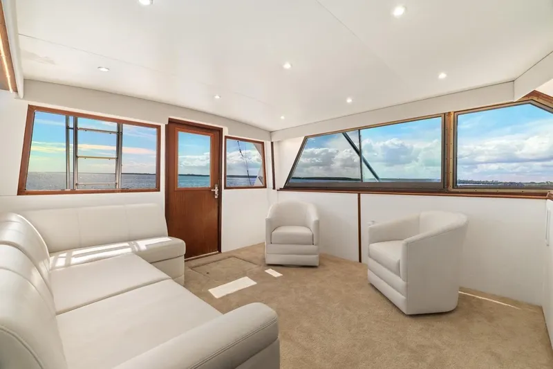 Slide: The Image of Luxurious interior of 1978 Hatteras 45 Convertible yacht with panoramic ocean views. - 27