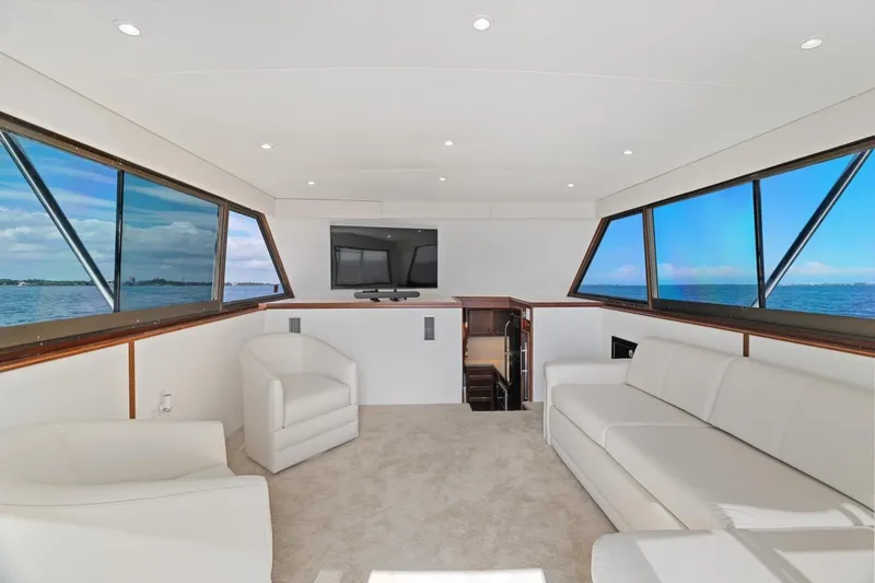 Slide: The Image of Luxurious interior of 1978 Hatteras 45 Convertible yacht with panoramic windows and modern seating. - 29