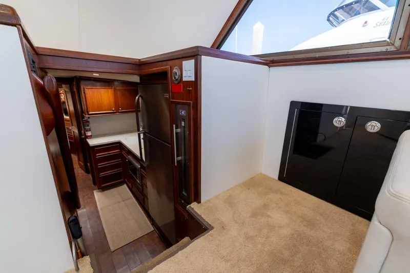 Slide: The Image of Interior of 1978 Hatteras 45 Convertible yacht with modern kitchen and wood cabinetry. - 33
