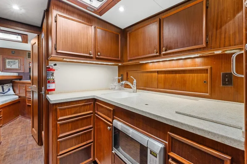 Slide: The Image of 1978 Hatteras 45 Convertible yacht kitchen with wood cabinets and modern appliances. - 35