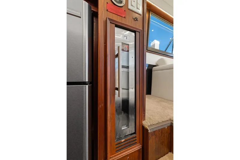 Slide: The Image of Interior of 1978 Hatteras 45 Convertible yacht with wooden paneling and modern appliances. - 38