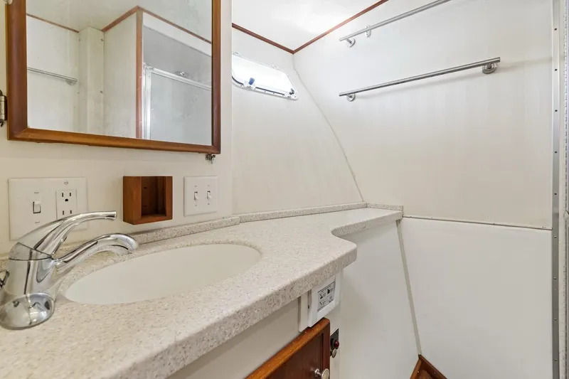 Slide: The Image of Bathroom interior of 1978 Hatteras 45 Convertible yacht with sink and mirror. - 41