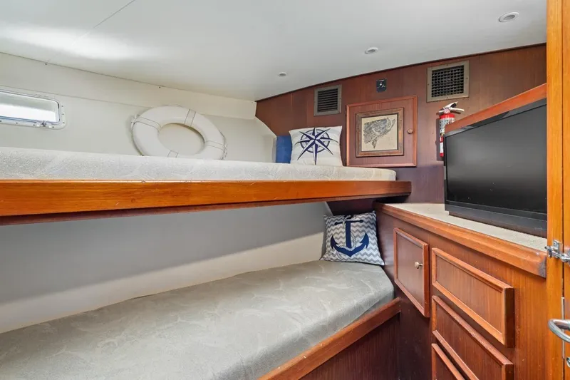 Slide: The Image of Cozy cabin interior of 1978 Hatteras 45 Convertible with bunk beds and nautical decor. - 42
