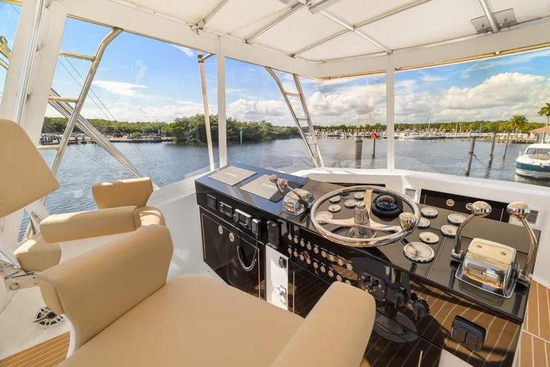 Slide: The Image of Helm of 1978 Hatteras 45 Convertible yacht with scenic marina view. - 44
