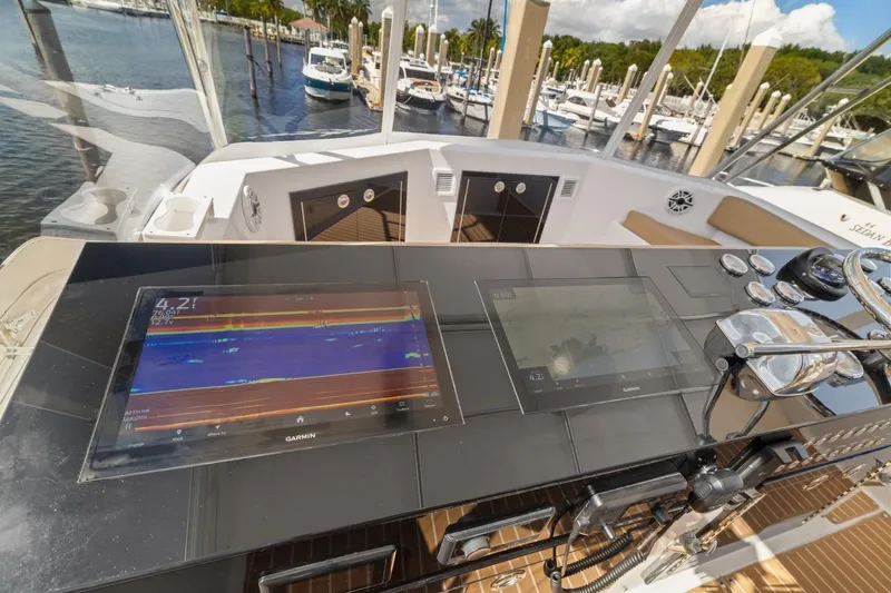 Slide: The Image of 1978 Hatteras 45 Convertible yacht helm with Garmin navigation displays at marina. - 47